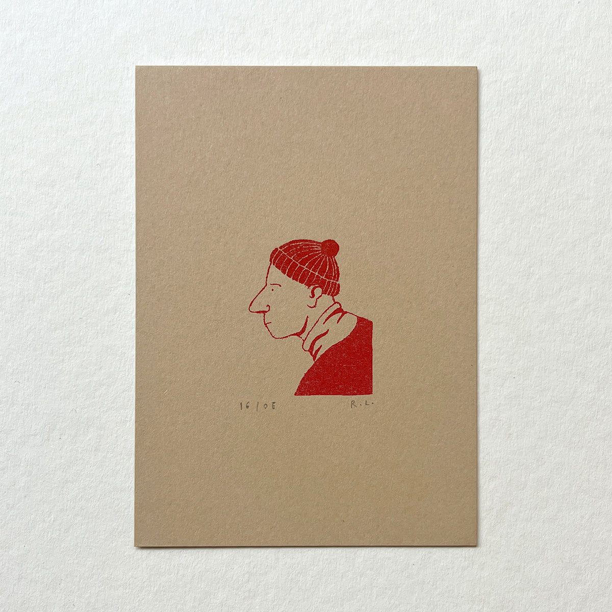 Beige card with red illustration of a person wearing a knit hat on a white background