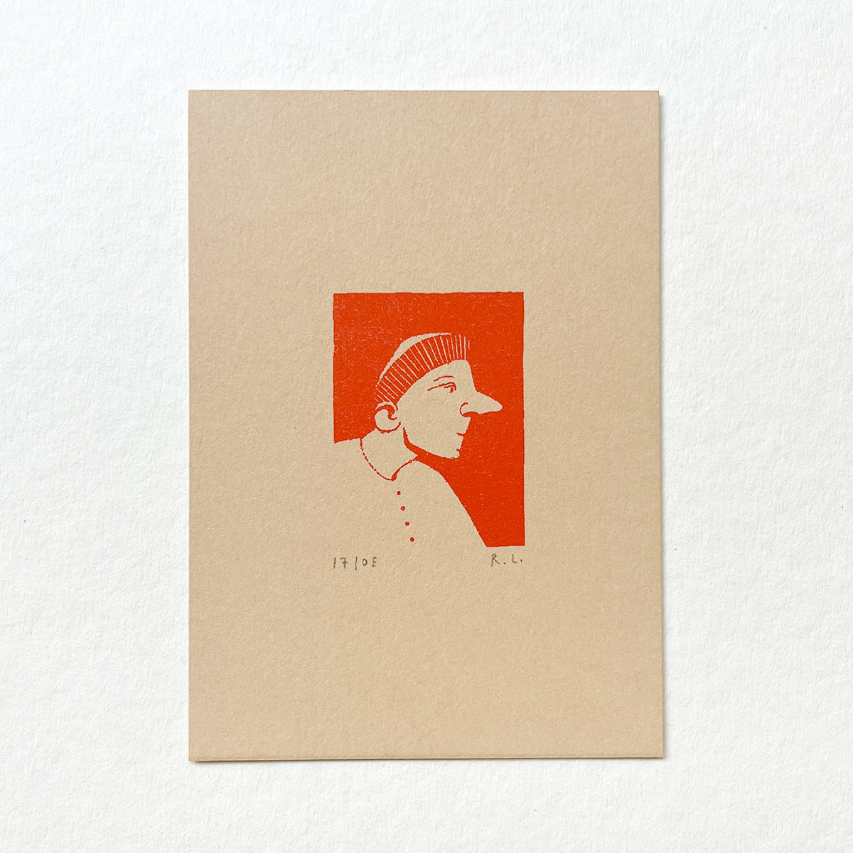 A minimalist art print on textured beige paper featuring a stylized profile portrait in red ink against a white background.