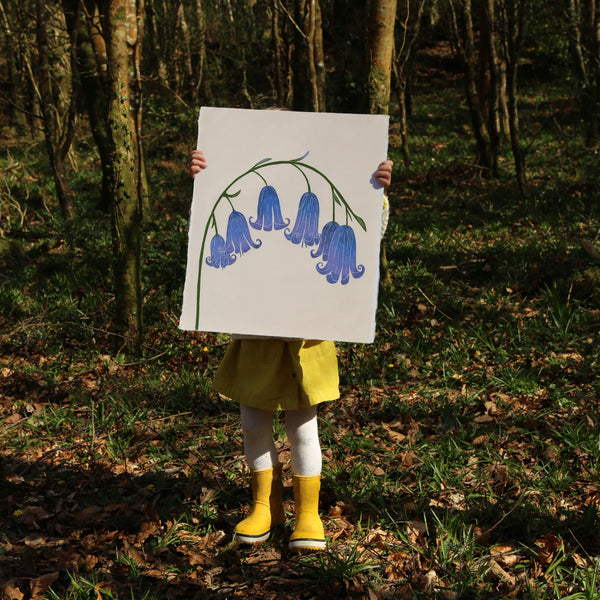 A child holding a Print of bluebells by Superfolk, made by block print on japanese washi paper. 
