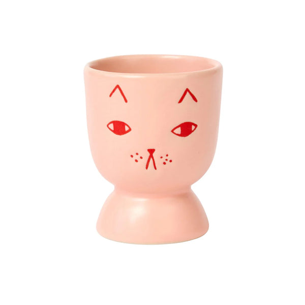 Donna Wilson Pink egg cup with red cat face design on a white background