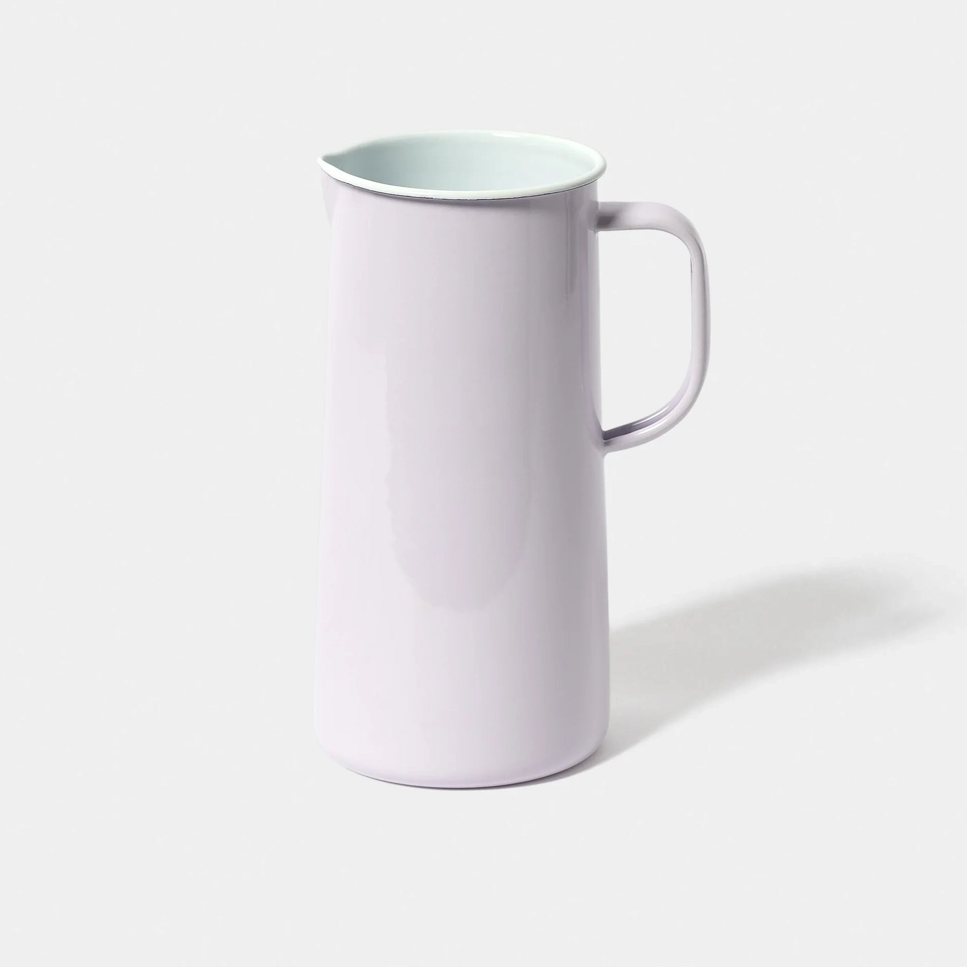 Pale lilac enamel falconware jug on a white background 