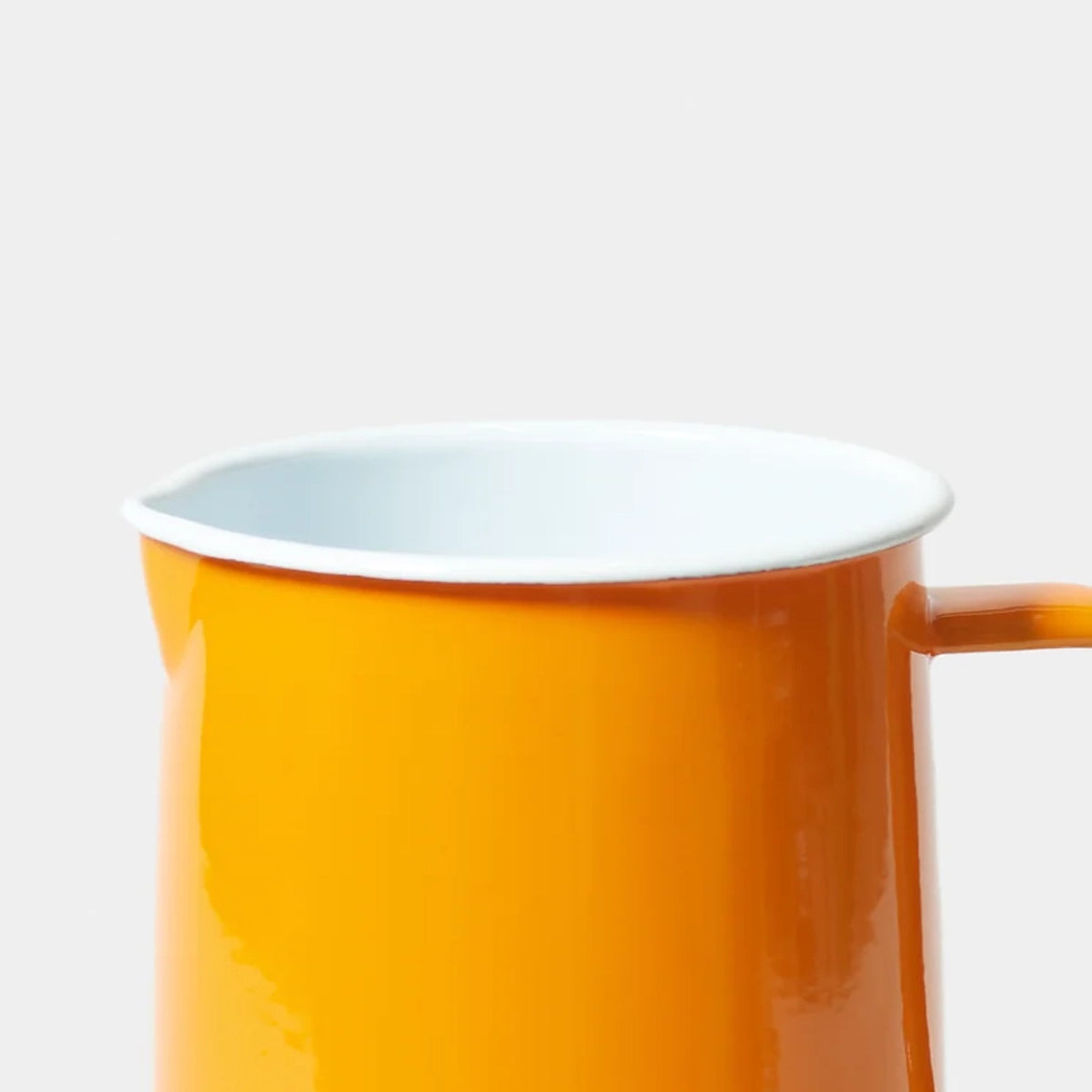 Orange tangerine falconware enamel jug  a white background