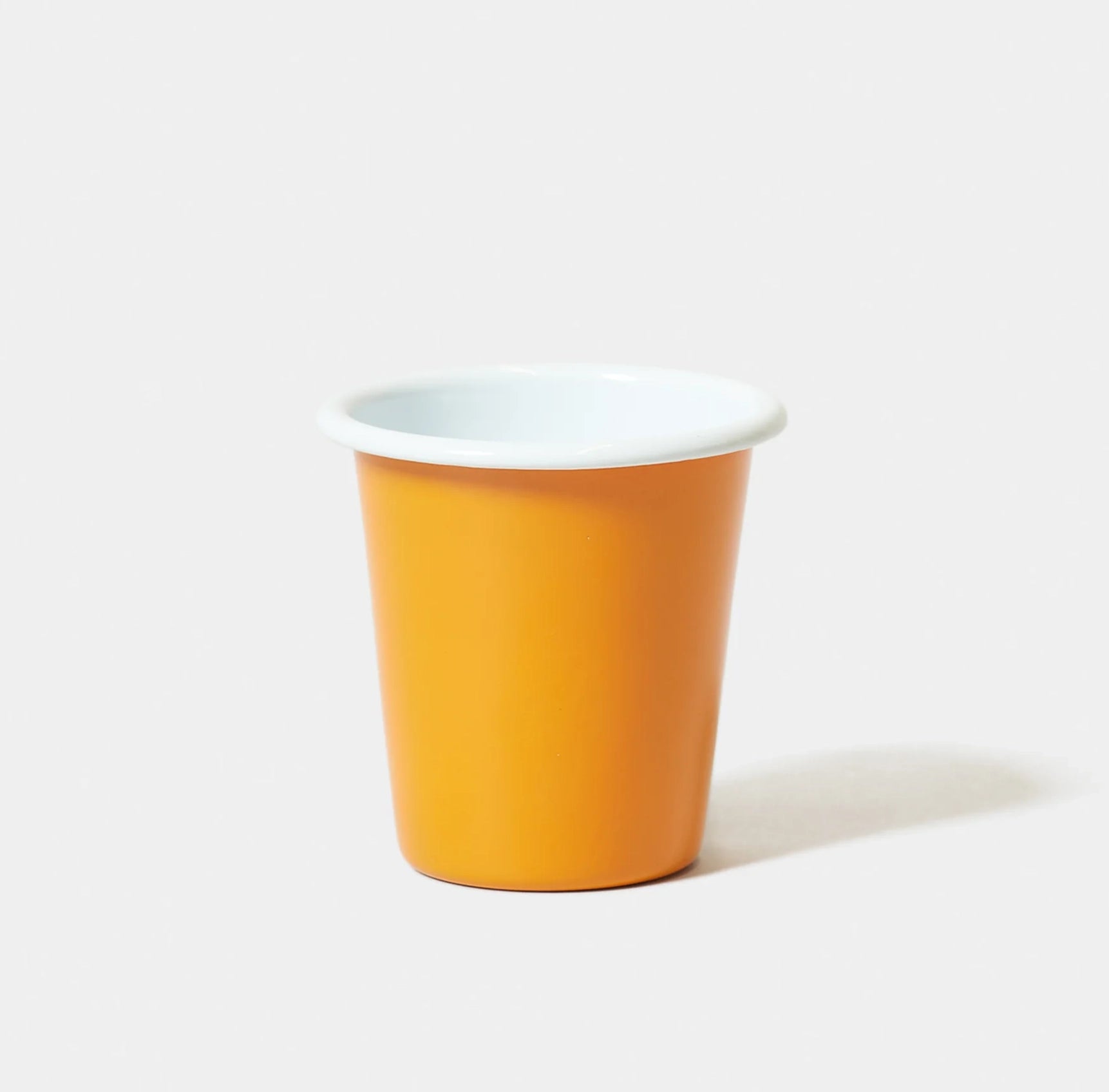 Orange Tangerine enamel falconware tumbler with white rim on white background