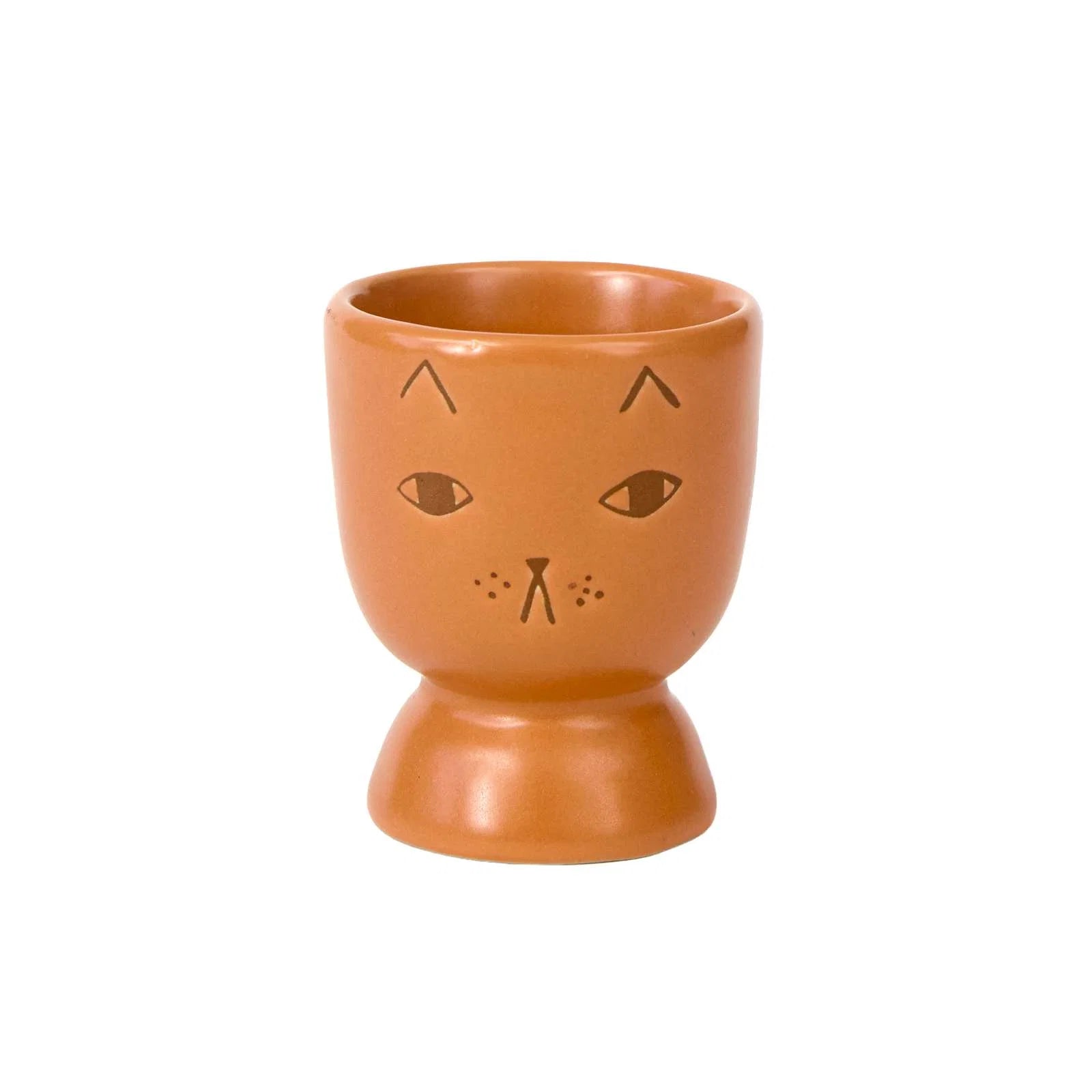 Ceramic egg cup with cat face design on a white background