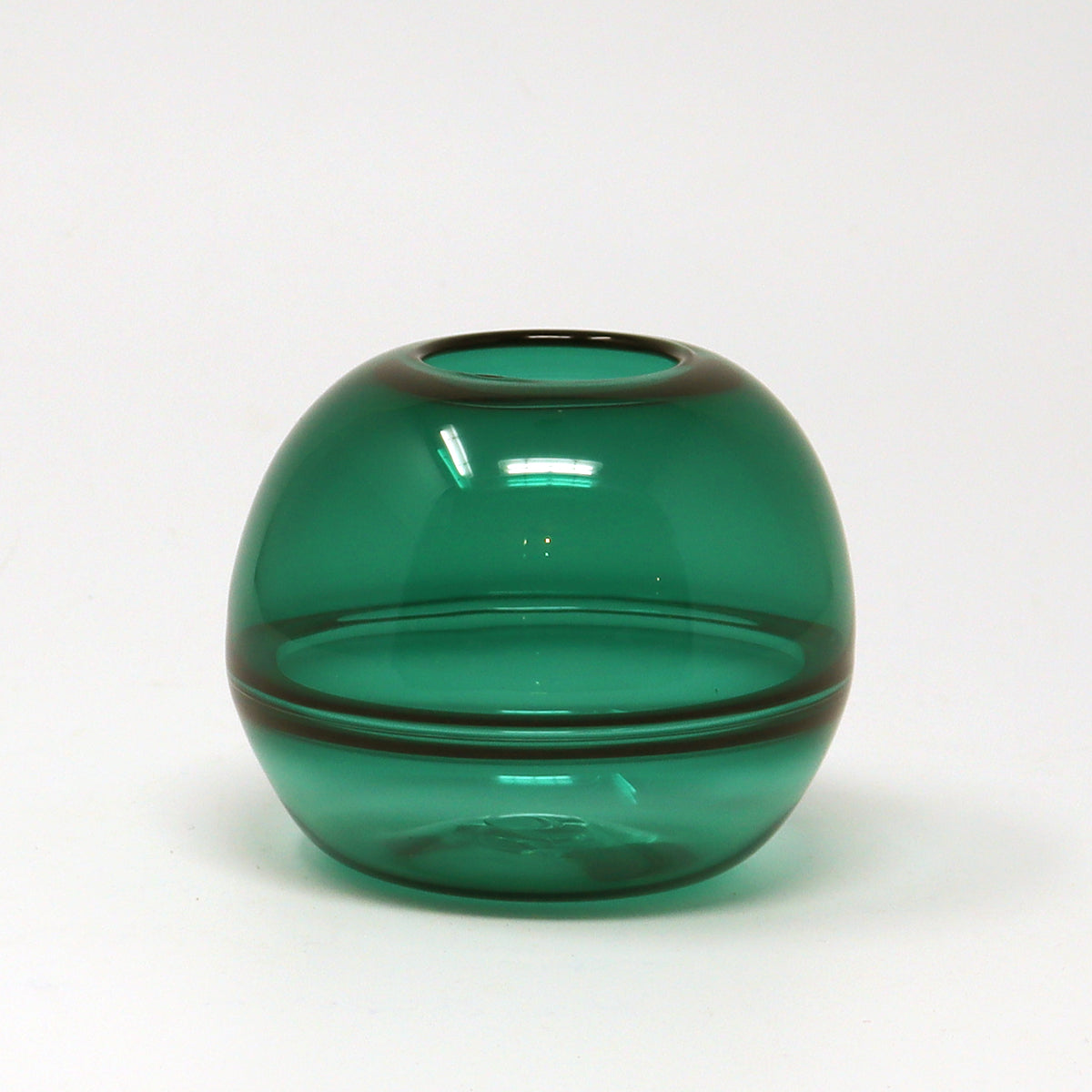 Green glass hand blown bud vase on a white background