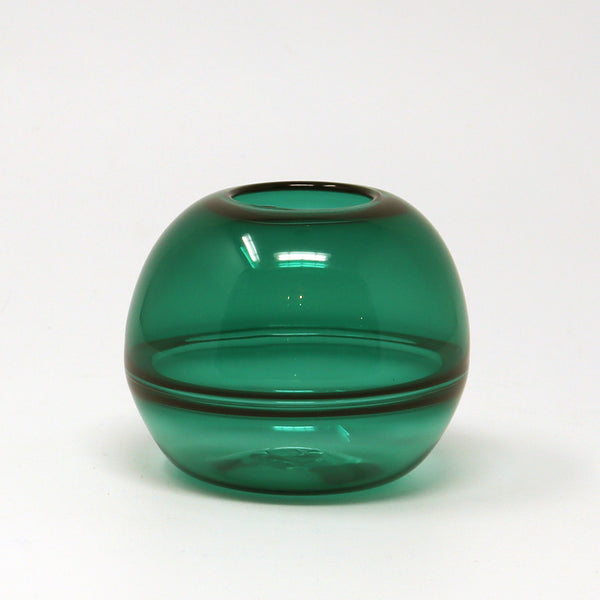 Green glass hand blown bud vase on a white background