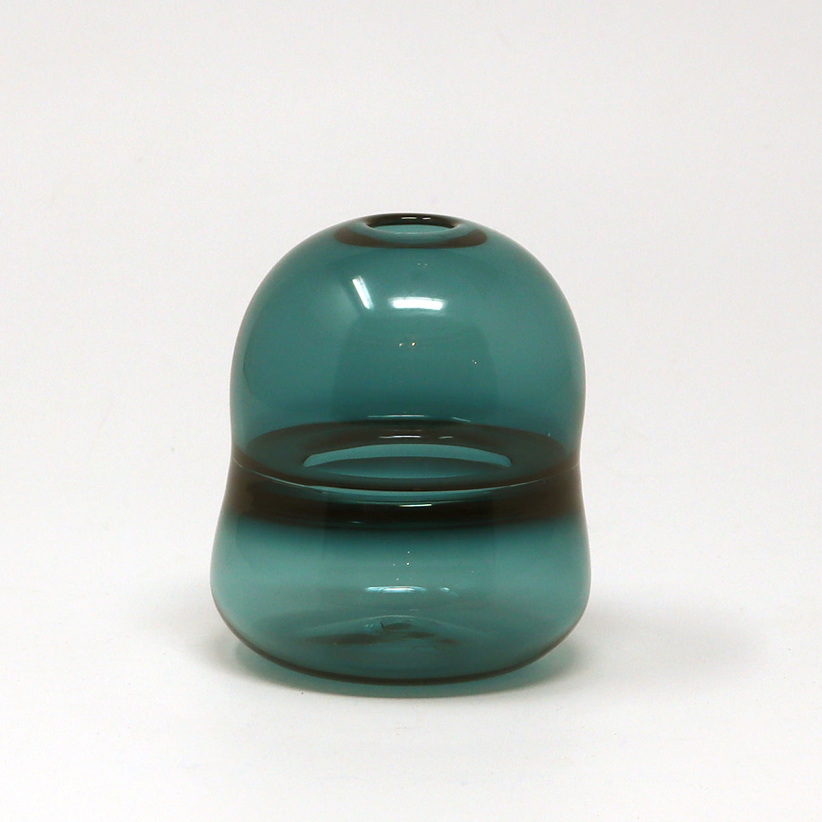 Teal glass bud vase on a white background