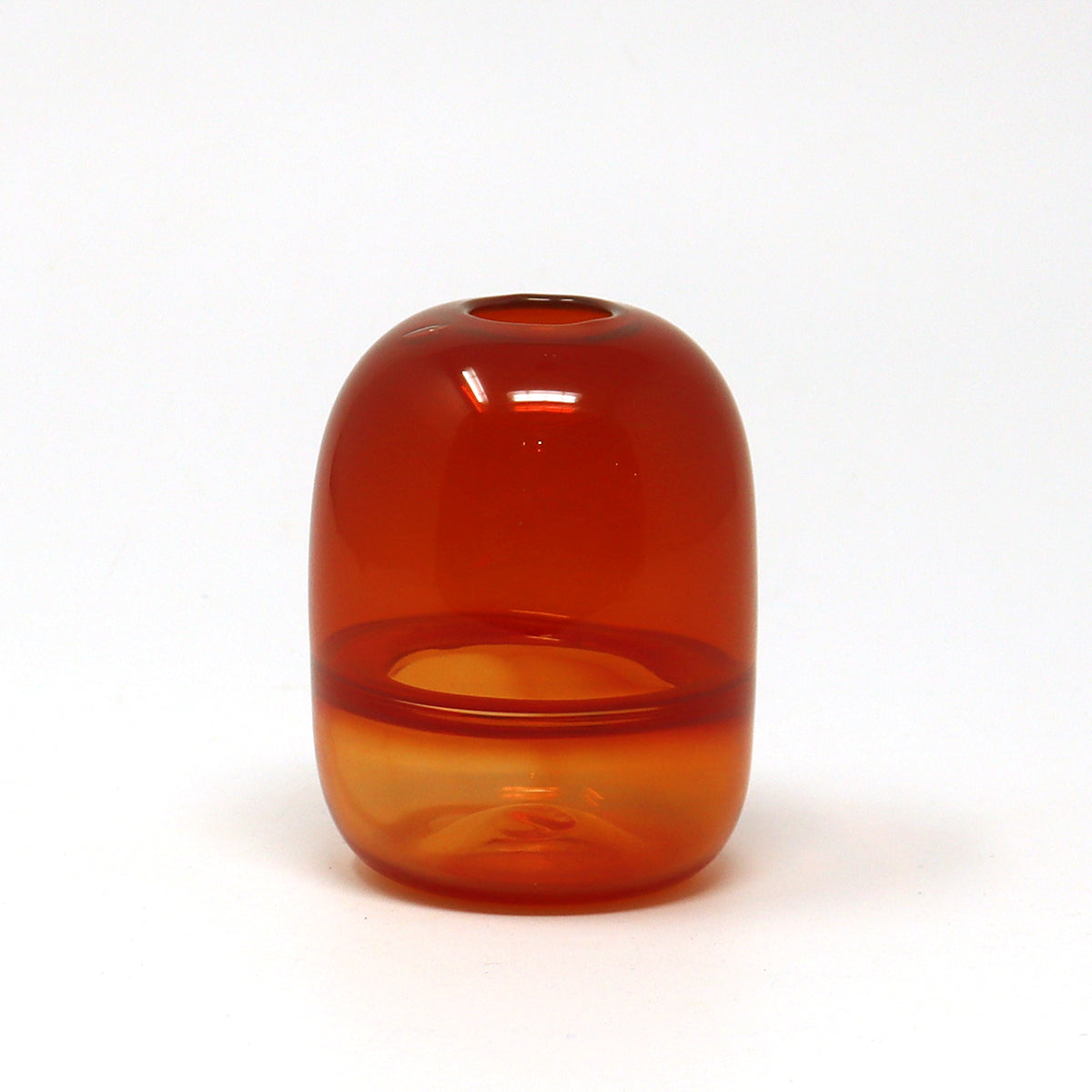 Red orange hand blown glass bud vase on a white background by Emma Baker