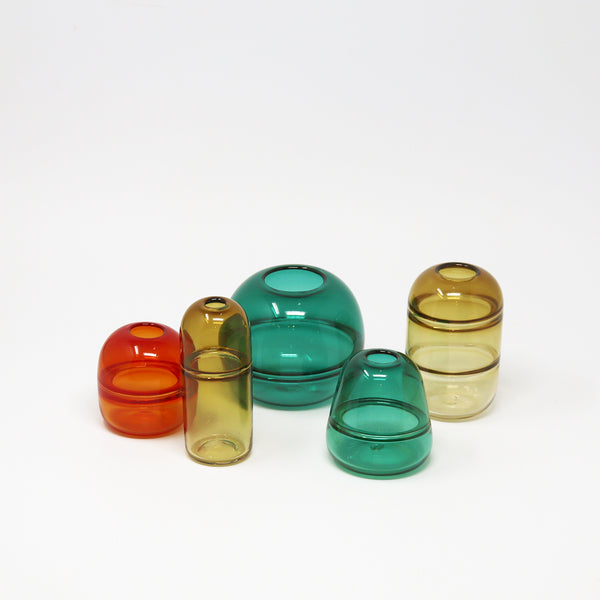 Set of colourful glass vases on a white background