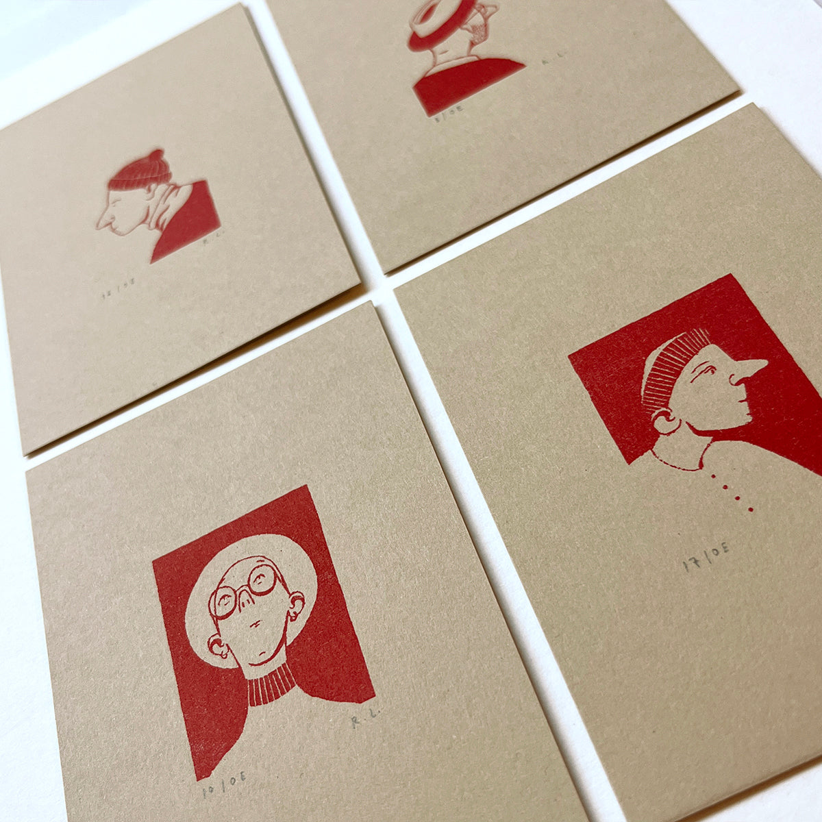 Set of four beige cards with red illustrations of people on a white background