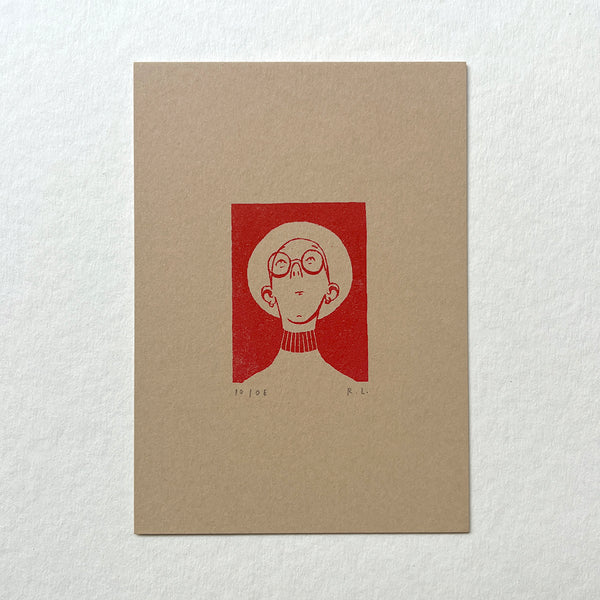 Beige notebook with a red illustration of a person wearing glasses, with a wide-brimmed hat, looking up on a white background
