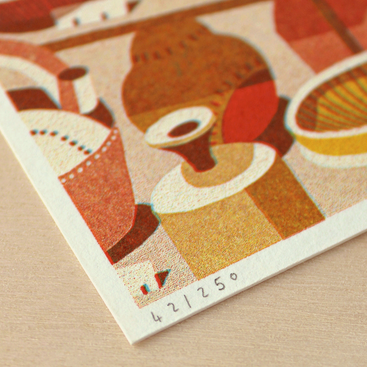 Close-up of a vintage-style illustration with geometric shapes and patterns on a textured surface.