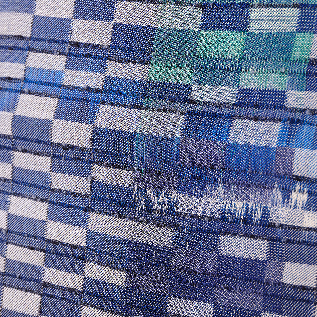 Close-up of blue and white woven textile artwork.