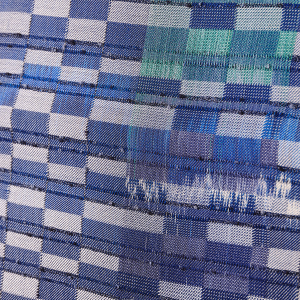 Close-up of blue and white woven textile artwork.