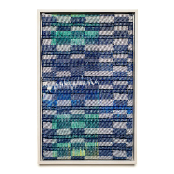 Framed textile art with blue and green pattern on a white background