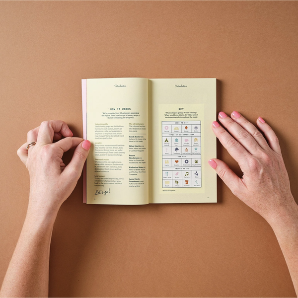 Open book with icons on a brown background