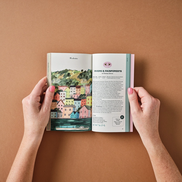 Open book held by hands on a brown background