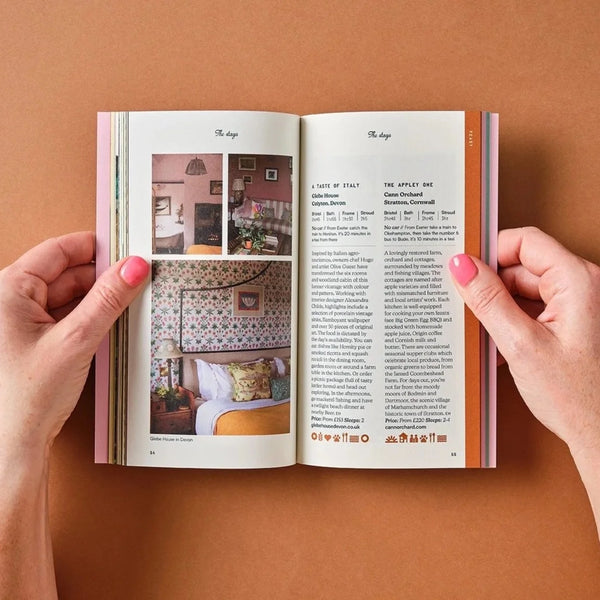 Open book held by hands on a brown background