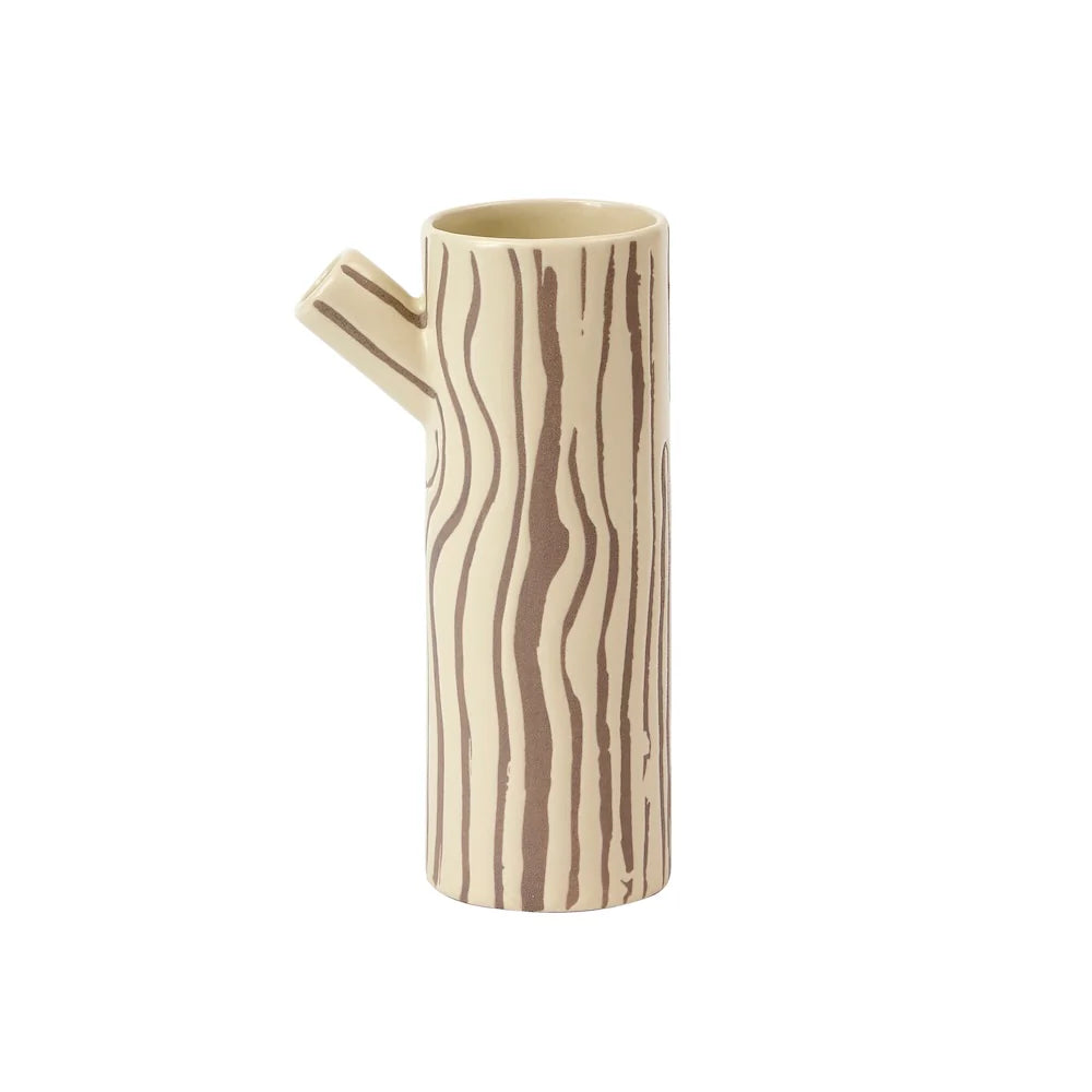 Brown and beige jug in the shape of a log with a tree bark design on a white background