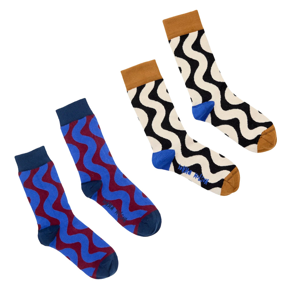 Two pairs of wiggle patterned socks displayed on a clean white background. The left pair features a blue and red wavy pattern with dark blue cuffs and toes.