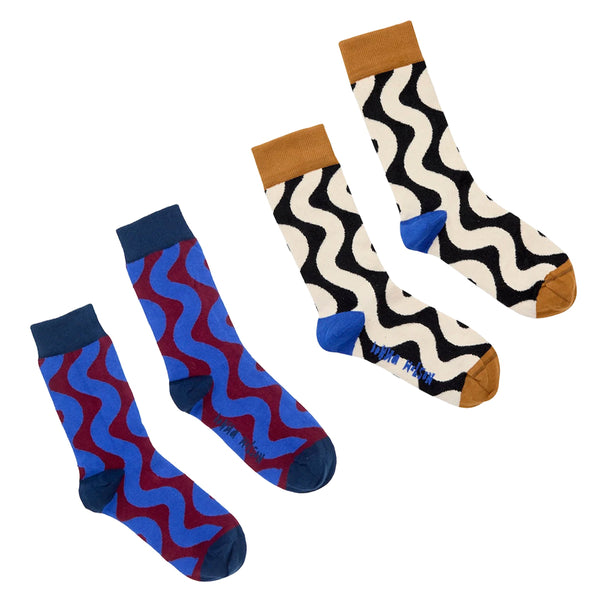 Two pairs of wiggle patterned socks displayed on a clean white background. The left pair features a blue and red wavy pattern with dark blue cuffs and toes.
