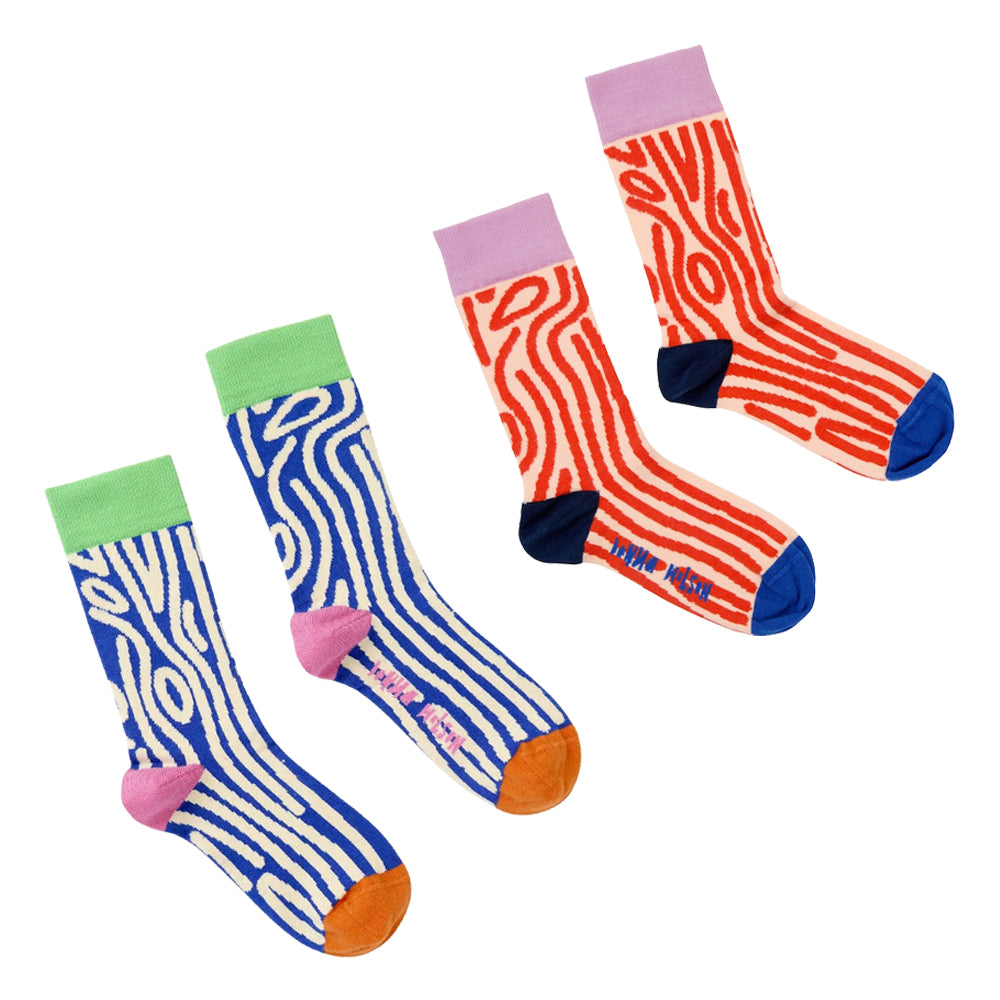 Two pairs of patterned crew socks displayed on a clean white background. The left pair features wavy blue and white woody stripes with pink heels and orange toes.