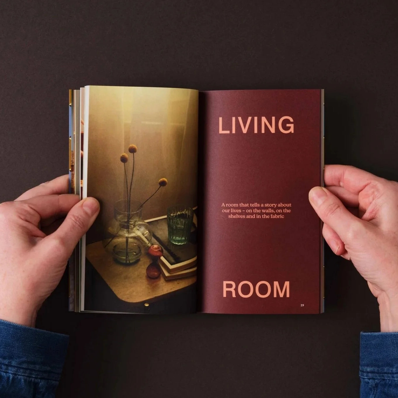 Open book showing a living room scene with text on a dark background